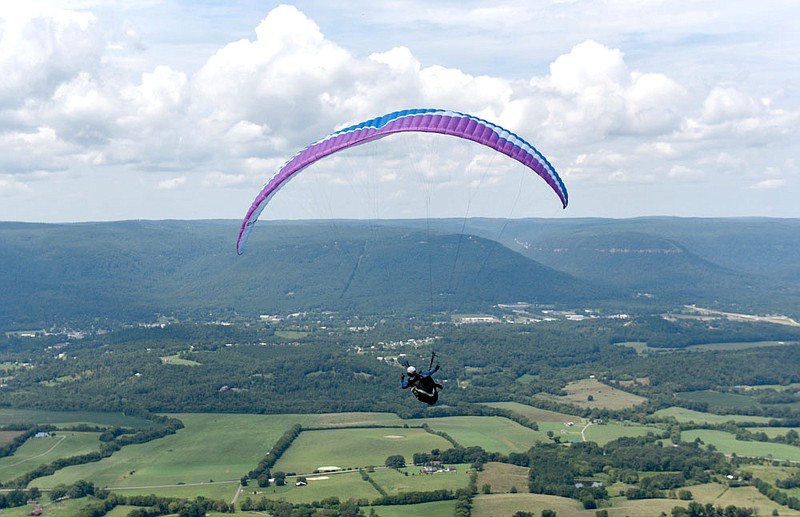 Staff File Photo / Rick Jacob guides his parasail over the Sequatchie Valley on Aug. 22, 2015, after launching from the bluff of Walden's Ridge in Dunlap, Tenn. People from around the country and around the world come to the Tennessee Tree Toppers launch site.