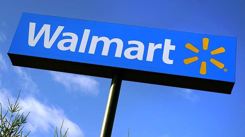 FILE - In this Nov. 18, 2020 file photo, a Walmart store sign is visible from Route 28 in Derry, N.H. Walmart Inc., reported on Thursday, Feb. 18, 2021, that it swung to a loss in the fiscal fourth quarter as the sale of its Japan and United Kingdom divisions weighed on results. (AP Photo/Charles Krupa, File)