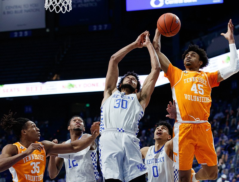 Southeastern Conference photo / Tennessee's Keon Johnson and Kentucky's Olivier Sarr fight for a rebound during the 82-71 win by the Volunteers in Rupp Arena on Feb. 6. Johnson scored a career-high 27 points against the Wildcats.