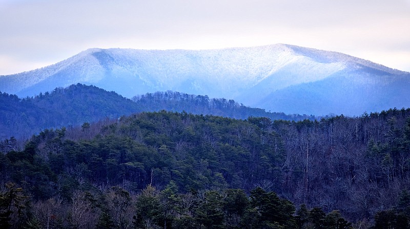 Staff Photo by Robin Rudd/ The crest of Big Frog Moutain, frosted with snow, rises above the Ocoee River in the Cherokee National Forest. The mountain, 4,222 feet high, was capped with snow on January 20, 2020.