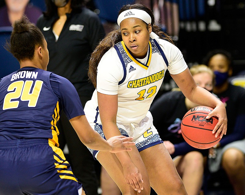 Staff photo by Robin Rudd / UTC's Bria Dial dribbles outside the 3-point line as UNC Greensboro's Jaylynn Brown defends during Friday's game at McKenzie Arena. Dial scored a game-high 16 points, and the Mocs never trailed, leading 34-17 at halftime and winning 57-41.