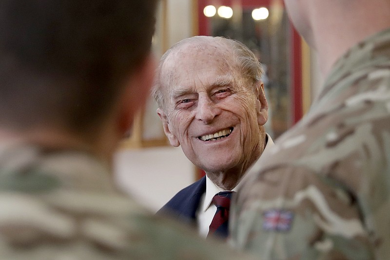 In this file photo dated Thursday, March 30, 2017, Britain's Prince Philip, in his capacity of Colonel, Grenadier Guards, talks to Sergeants from 1st Battalion Grenadier Guards as he walks in their Mess at Lille Barracks in Aldershot, England. The 99-year-old husband of Queen Elizabeth II, Prince Philip was admitted to King Edward VII Hospital on Tuesday evening as "a precautionary measure" and is expected to remain there for a few days of "observation and rest." (AP Photo/Matt Dunham, FILE)