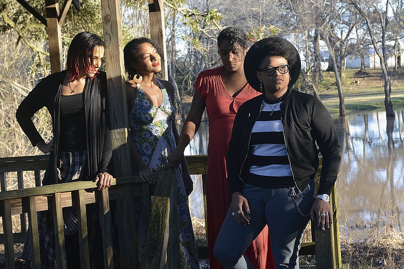 This image released by Smithsonian Channel shows, from left, Rhiannon Giddens, Allison Russell, Leyla McCalla and Amythyst Kiah, of Our Native Daughters, near Parks, La., on Jan. 29, 2018. The group will appear in the documentary "Reclaiming History: Our Native Daughters" premiering Monday on Smithsonian Channel. (Terri Fensel/Smithsonian Channel via AP)