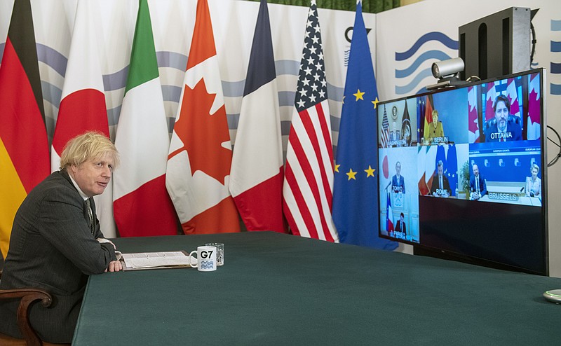 Britian's Prime Minister Boris Johnson hosts a virtual meeting of G7 world leaders, from within the Cabinet Room at Downing Street in London, Friday Feb. 19, 2021. Johnson is chairing a virtual meeting Friday with leaders of the Group of Seven economic powers, holding their first meeting of 2021. (Geoff Pugh/Pool via AP)