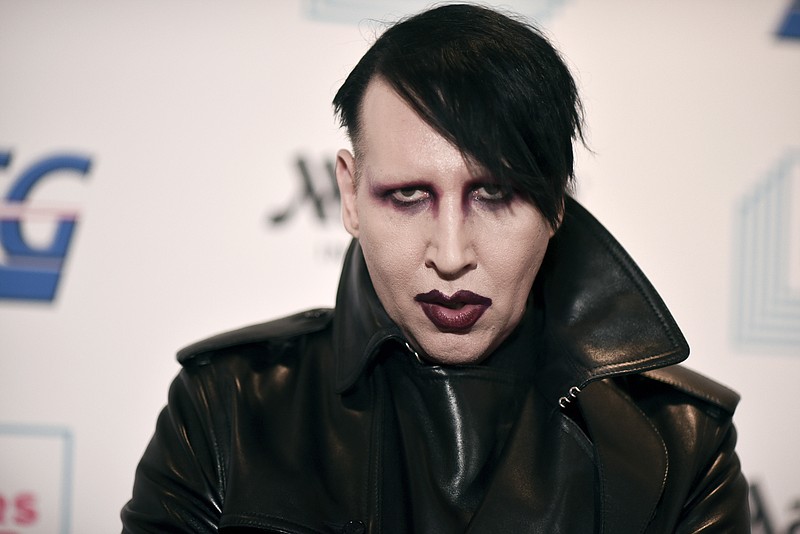 In this Dec. 10, 2019, file photo, Marilyn Manson attends the 9th annual "Home for the Holidays" benefit concert in Los Angeles. Detectives are investigating Manson for allegations of domestic violence that reportedly occurred about a decade ago in West Hollywood, authorities said. The domestic violence is believed to have occurred between 2009 and 2011, when Manson lived in the city of West Hollywood. (Photo by Richard Shotwell/Invision/AP, File)