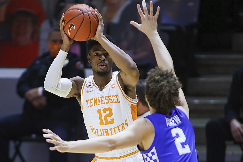 Pool photo by Randy Sartin via AP / Tennessee's Victor Bailey Jr. looks to pass while guarded by Kentucky's Devin Askew during Saturday's game in Knoxville.