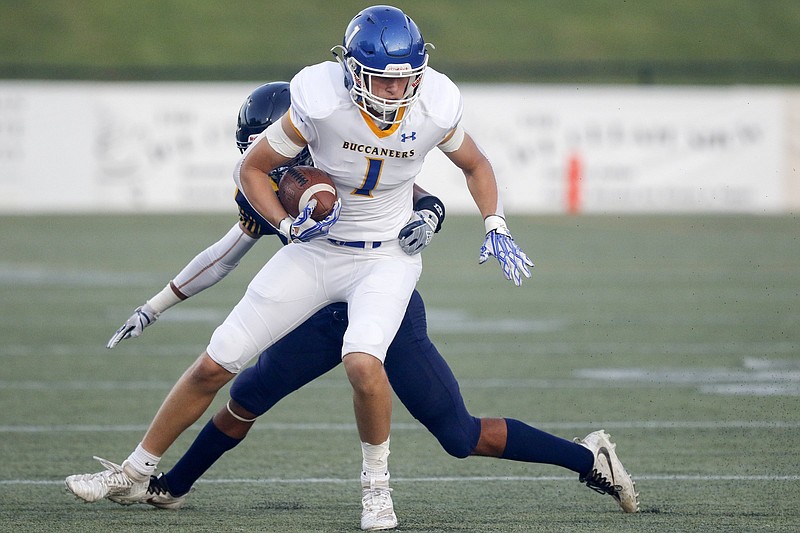 Staff photo by C.B. Schmelter / Boyd Buchanan's Karson Gay tries to escape a tackle attempt by Chattanooga Christian School's Zion Irvin on Sept. 20, 2019, at CCS.