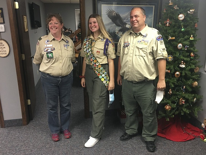 This Oct. 1, 2020 photo provided by Edmund Tunney shows his daughter, Isabella, center, with Bev Verweg, her scoutmaster, and Brian Reiners, the scoutmaster of the corresponding linked boy troop, in Edina, Minn. (Edmund Tunney via AP)


