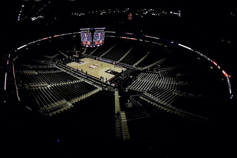 Big 12 commissioner Bob Bowlsby speaks on the scoreboard screen in an empty Sprint Center after canceling the remaining NCAA college basketball games in the Big 12 Conference tournament due to concerns about the coronavirus on March 12, 2020, in Kansas City, Mo. (AP Photo/Charlie Riedel)       