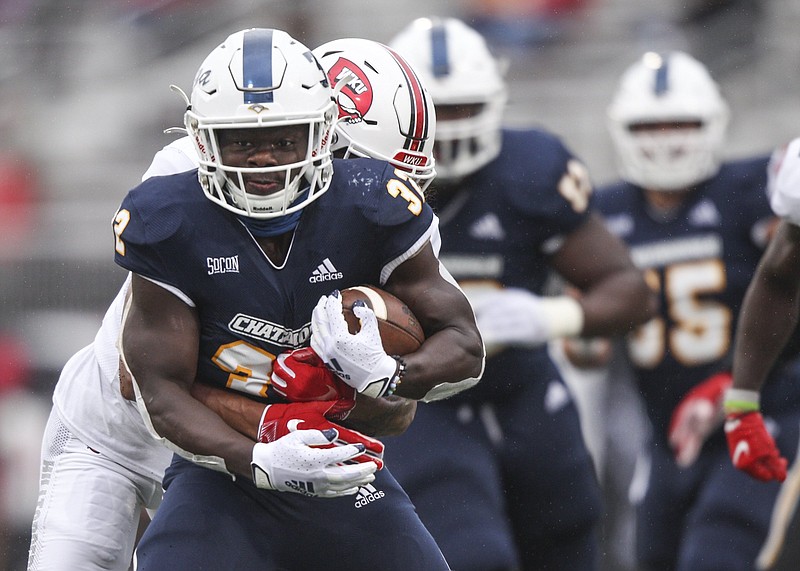 Staff photo by Troy Stolt / Chattanooga Mocs running back Ailym Ford (32) fights off a tackle during the first half of the Chattanooga Mocs football game against the Western Kentucky Hilltoppers at Houchens Industries-L.T. Smith Stadium on Saturday, Oct. 24, 2020 in Bowling Green , Kentucky.