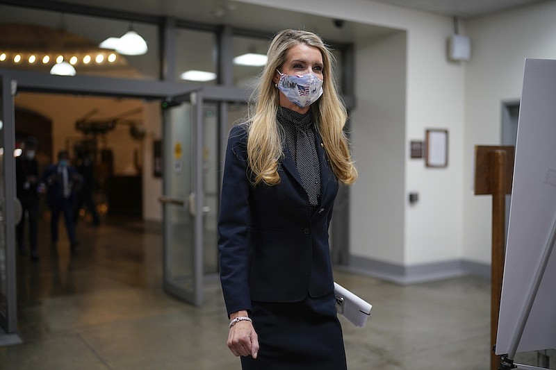 Sen. Kelly Loeffler, R-Ga., one of two Republican candidates who were defeated in Georgia's pivotal Senate runoff elections, arrives on Capitol Hill as the Senate returns to work, in Washington, Tuesday, Jan. 19, 2021, a day before President-elect Joe Biden is sworn in as the 46th president. (AP Photo/J. Scott Applewhite)