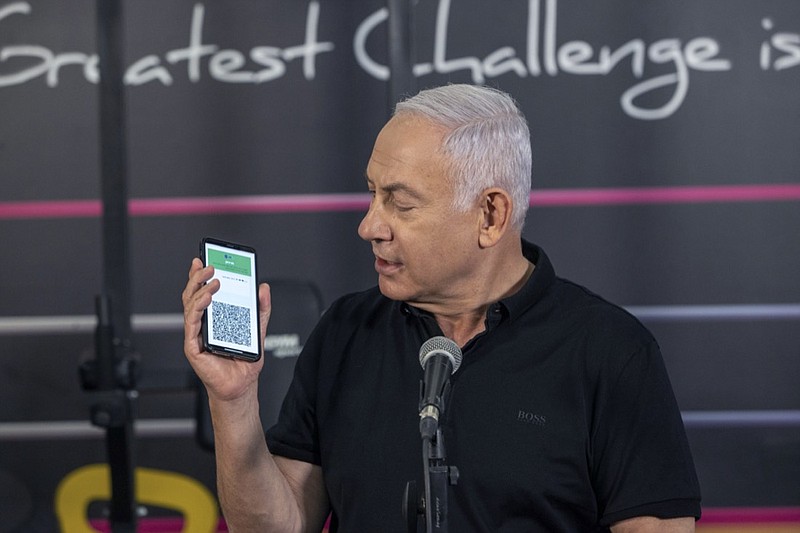 Israeli Prime Minister Benjamin Netanyahu talks to the media during a visit to the Fitness gym ahead of the re-opening of the branch in Petah Tikva, Israel, on Saturday, Feb. 20, 2021. (AP Photo/Tal Shahar, Yediot Ahronot, Pool)