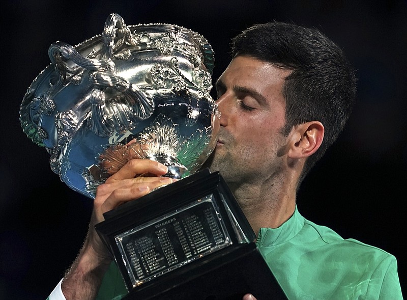 Serbia's Novak Djokovic kisses the Norman Brookes Challenge Cup after defeating Russia's Daniil Medvedev in the men's singles final at the Australian Open tennis championship in Melbourne, Australia, Sunday, Feb. 21, 2021.(AP Photo/Mark Dadswell)