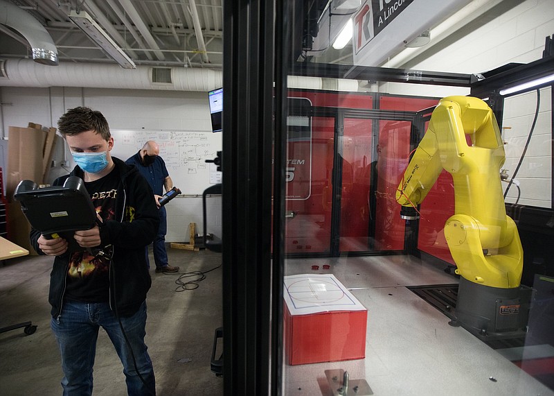 Staff photo by Troy Stolt / Chattanooga State student Ben Stipanov works with a robot during his class inside the Center for Engineering Technology, Arts & Sciences on campus in February.