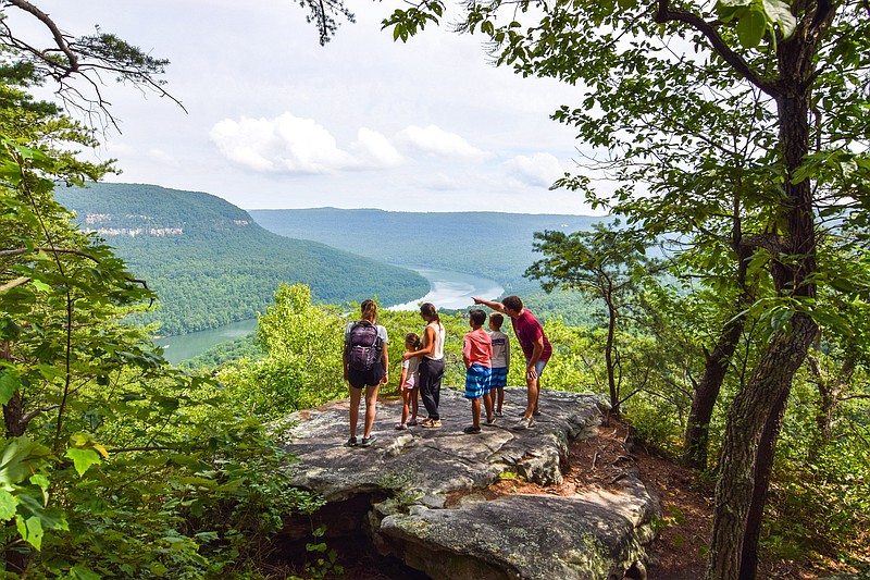 Contributed photo by Ryan Maum / A group of hikers stand on a rock overlooking the Tennessee River Gorge during a guided hike with Ryan and Hope Maum of Experience Chattanooga.