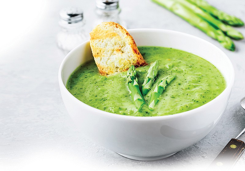 Getty Images / Asparagus cream soup served with croutons.