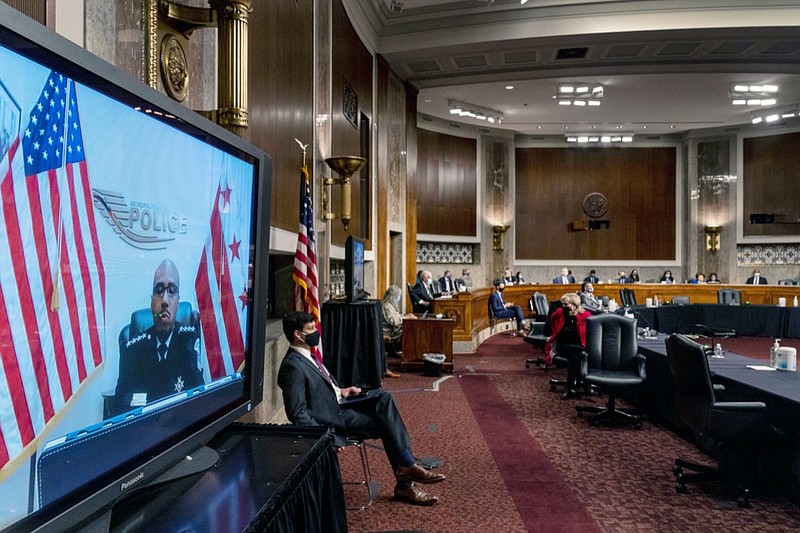 Washington Metropolitan Police Department Acting Chief of Police Robert Contee III, left, testifies via teleconference before a Senate Homeland Security and Governmental Affairs & Senate Rules and Administration joint hearing on Capitol Hill, Washington, Tuesday, Feb. 23, 2021, to examine the January 6th attack on the Capitol. (AP Photo/Andrew Harnik, Pool)