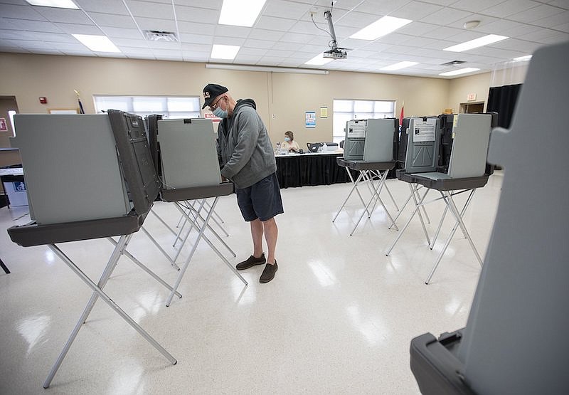 Staff photo by Troy Stolt / Dennis O'Rear casts his ballot for the upcoming Hamilton County local elections at the Hamilton County Election Commission on Wednesday, Feb. 10, 2021 in Chattanooga, Tenn.