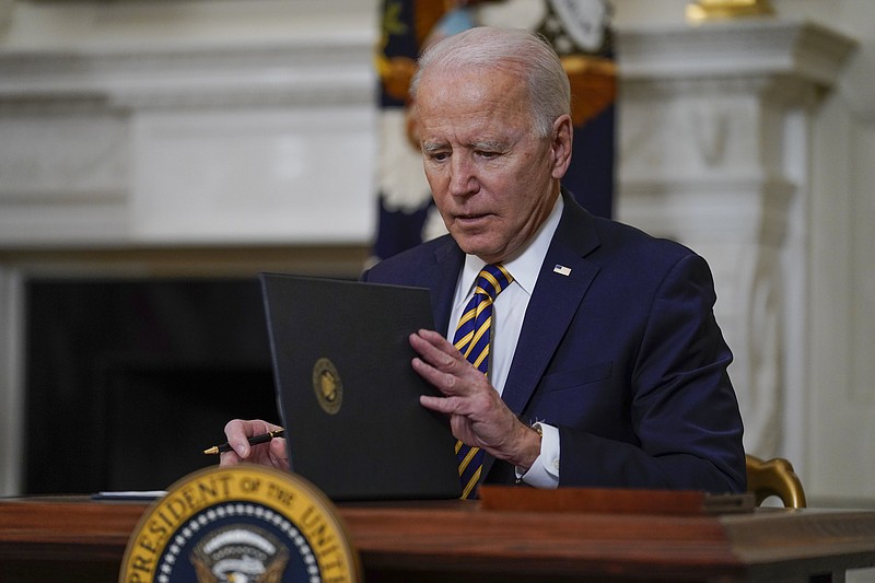 President Joe Biden closes the folder after signing an executive order relating to U.S. supply chains, in the State Dining Room of the White House, Wednesday, Feb. 24, 2021, in Washington. (AP Photo/Evan Vucci)