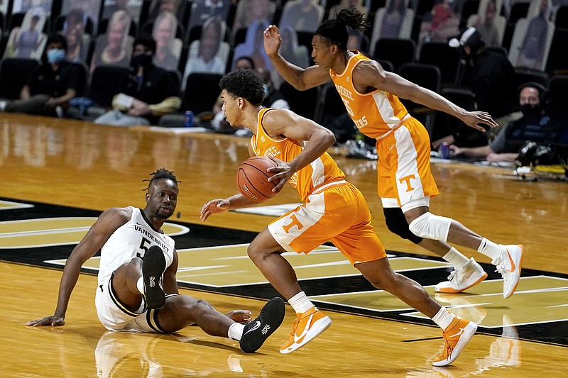 AP photo by Mark Humphrey / Tennessee's Jaden Springer, center, and Yves Pons, right, head downcourt past Vanderbilt's Ejike Obinna during the first half Wednesday night in Nashville.