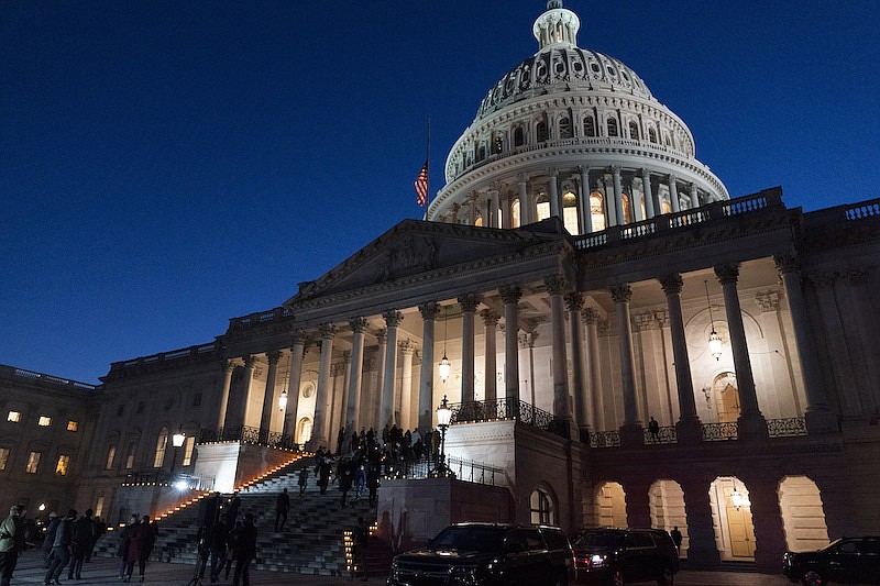 A bipartisan group of members of the House and Senate, walk back up the steps of the Capitol after holding a moment of silence for 500,000 U.S. COVID-19 deaths, Tuesday, Feb. 23, 2021, in Washington. (AP Photo/Jacquelyn Martin)