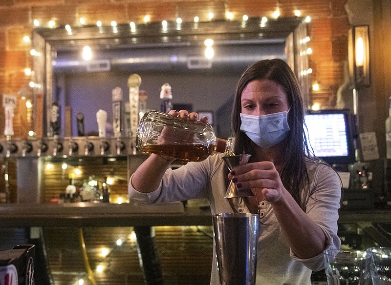 FILE - In this Nov. 23, 2020, file photo, Bartender Kellie Mottiqua prepares drinks at Bridgetown Taphouse in Ambridge, Penn. (Emily Matthews/Pittsburgh Post-Gazette via AP)


