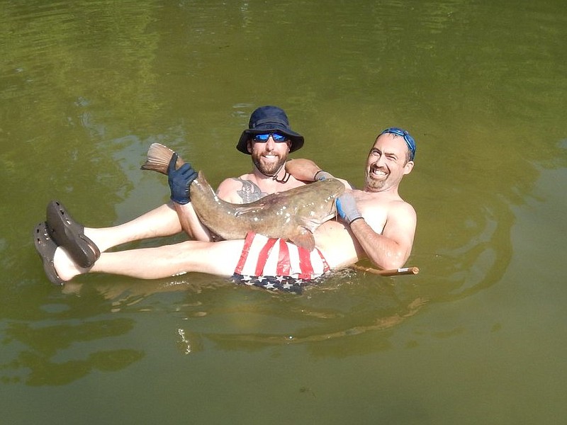 Photo contributed by Cody Buell/ Cody Buell (left) and Nathan Worthington became fast friends over their love of catfish noodling. 