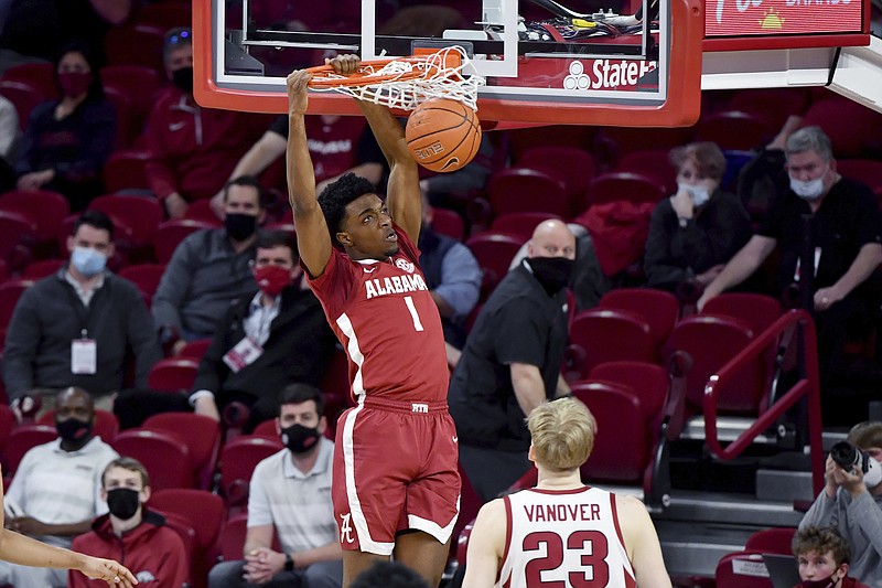 AP photo by Michael Woods / Alabama forward Herbert Jones dunks as Arkansas forward Connor Vanover watches during Wednesday night's game in Fayetteville. Sixth-ranked Alabama lost by 15 points to the No. 20 Razorbacks, but the Crimson Tide are 18-6 overall, 13-2 in the SEC and still in line for a high seed in next month's NCAA tournament.