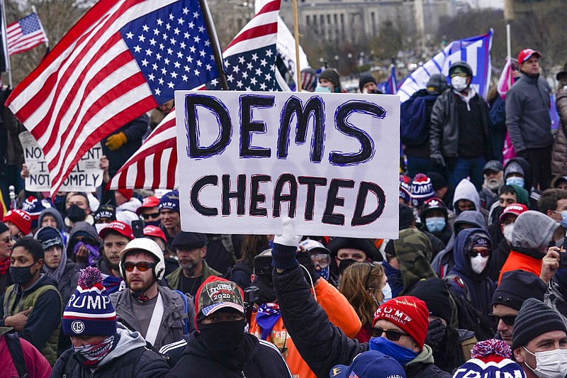 In this Wednesday, Jan. 6, 2021 file photo, Trump supporters gather outside the Capitol in Washington. A faction of local, county and state Republican officials across the country is pushing lies, misinformation and conspiracy theories online that echo those that helped inspire the violent Capitol insurrection, forcing the GOP into an internal reckoning. (AP Photo/John Minchillo)