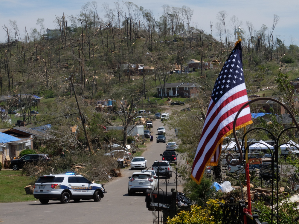Staff photo by Tim Barber/ Holly Hills Drive is crowded with vehicles passing the pool area Friday, Apr. 17, 2020, as a massive effort to clear rubble from the Easter night tornado continues in East Brainerd.