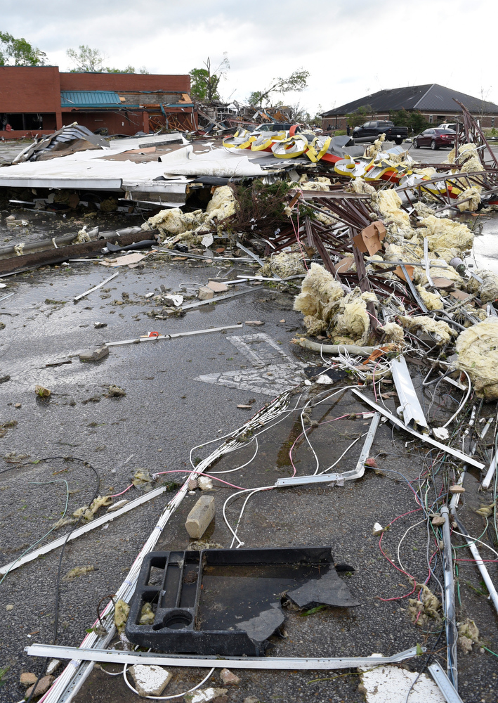 Staff Photo by Robin Rudd / A portion of the roof of the destroyed Advanced Auto Parts stores letters the parking lot of the Goodwill Store on East Brainerd Road. In the background is seen the destroyed Bones Smokehouse. The Chattanooga Area was hit by EF 3 tornado on the night of April 12, 2020.