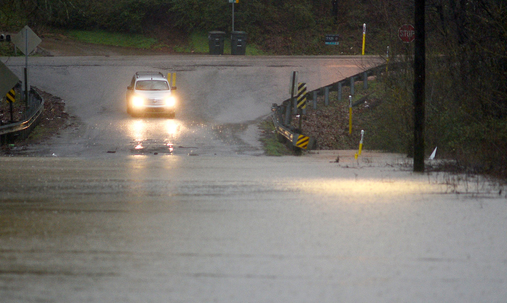 Staff Photo by Robin Rudd / A car begins to turnaround rather than risk the flood waters of Mackey Branch on Davidson Road. Heavy rain and flooding forced the closing of some local school systems on February 6, 2020.