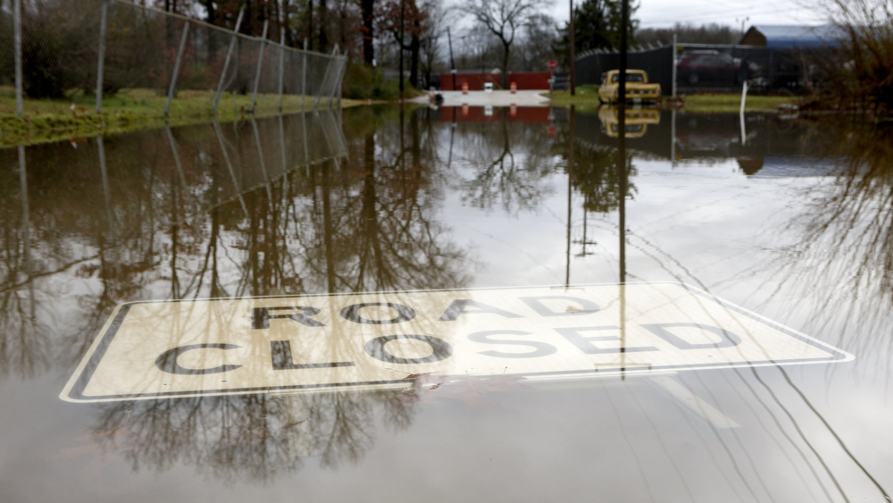 Staff photo by C.B. Schmelter / A "road closed" sign is seen covered by flood waters along the 2700 block of Cannon Avenue on Tuesday, Feb. 11, 2020 in Chattanooga, Tenn.