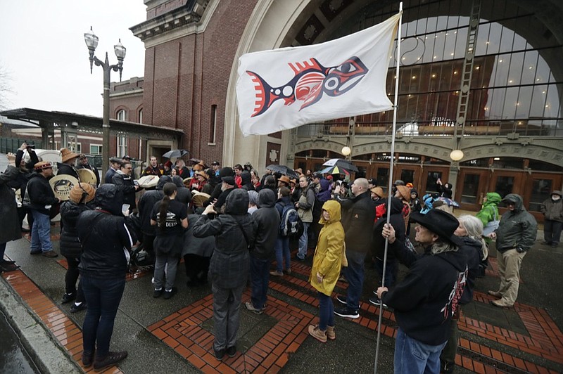 FILE - In this Jan. 6, 2020, file photo, the flag of the Chinook Indian Nation is displayed in the wind as tribal members and other supporters gather outside the federal courthouse in Tacoma, Wash., as they continue their efforts to regain federal recognition. (AP Photo/Ted S. Warren, File)


