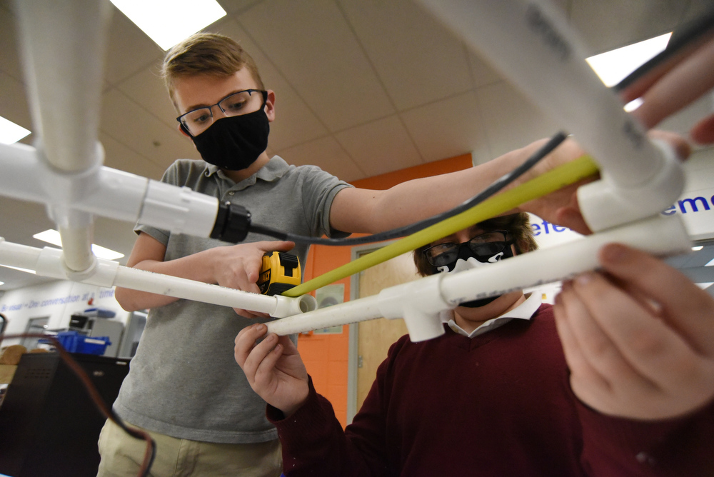 Staff Photo by Matt Hamilton / Cash Hess, left, works with Otis Rozema, both 12, as they build a remote operated vehicle at Howard Connect Academy on Wednesday, Feb. 24, 2021.