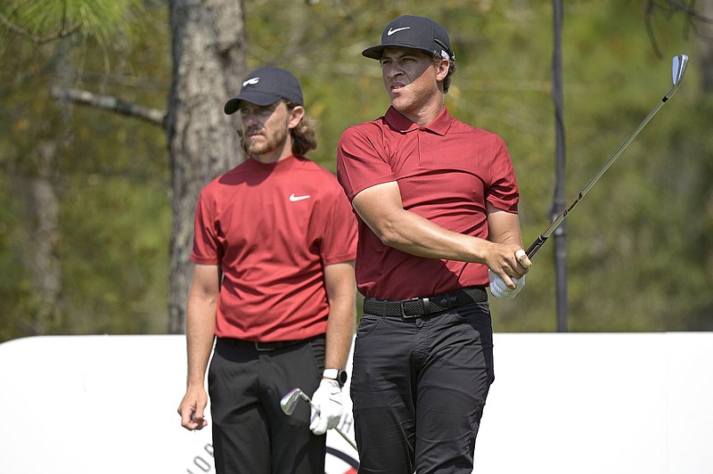 AP photo by Phelan M. Ebenhack / Tommy Fleetwood, left, and Cameron Champ watch Fleetwood's tee shot on the 11th hole during the final round of the Workday Championship at The Concession on Sunday in Bradenton, Fla. Each wore a red shirt and black pants to honor 15-time major champion Tiger Woods, who is recovering from serious injuries sustanined in a car crash Tuesday in Los Angeles.