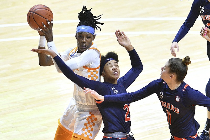 Knoxville News Sentinel photo by Saul Young via SEC / Tennessee's Rennia Davis, left, gets the rebound over Auburn's Alaina Rice during the regular-season finale for both teams Sunday in Knoxville.