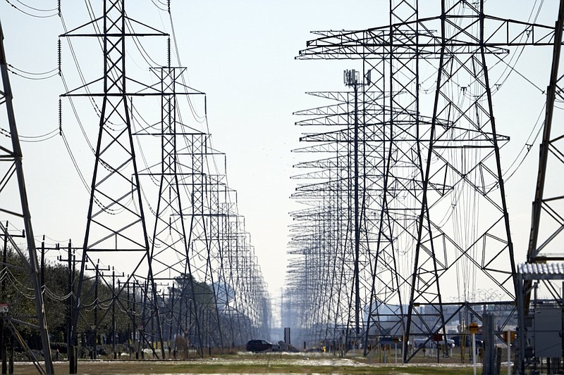 FILE - This Tuesday, Feb. 16, 2021, file photo shows power lines in Houston. When an unusually heavy winter storm blanketed much of Texas with snow, knocking out electricity to millions of homes and leaving many struggling to find clean water, one sector of the population was particularly vulnerable: inmates in Houston at the state's largest county jail. (AP Photo/David J. Phillip, File)