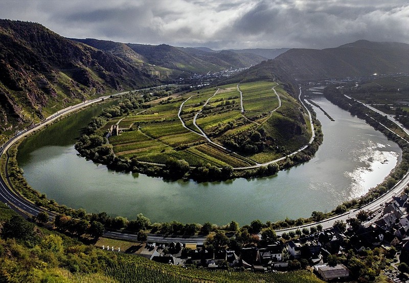 File---File picture taken Sept. 26, 2020 shows he Calmont vineyard standing over the Mosel loop in Bremm, Germany. The German disease control agency is adding France's Moselle region to its list of areas with a high rate of variant coronavirus cases, meaning travelers from there will face additional hurdles when crossing the border into neighboring Germany.(AP Photo/Michael Probst, file)