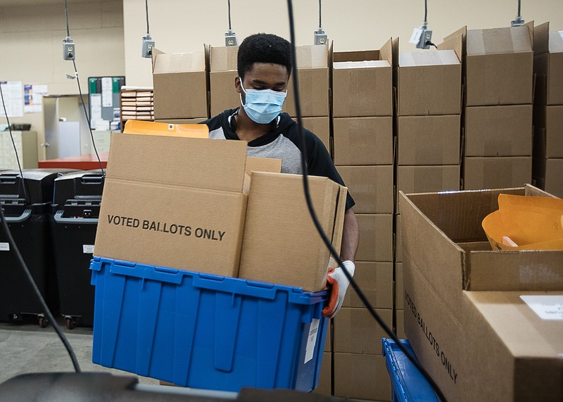 Staff photo by Troy Stolt / Election Commission worker Charlie Smith loads polling materials onto a cart in preparation for the upcoming local elections at the Hamilton County Election Commission on Monday, March 1, 2021, in Chattanooga, Tenn.