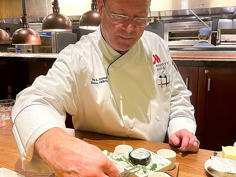 Chef Dean Donnell, food and beverage director at Marriott Shoals Hotel and Spa, garnishes a caviar course with microgreens grown locally to his specifications. / Photo by Anne Braly thumbnail