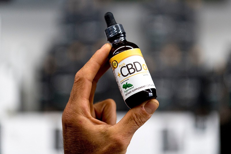 Contributed Photo / A bottle of CBD oil sold at a shop in West Knoxville, Tennessee, is shown by a store manager.