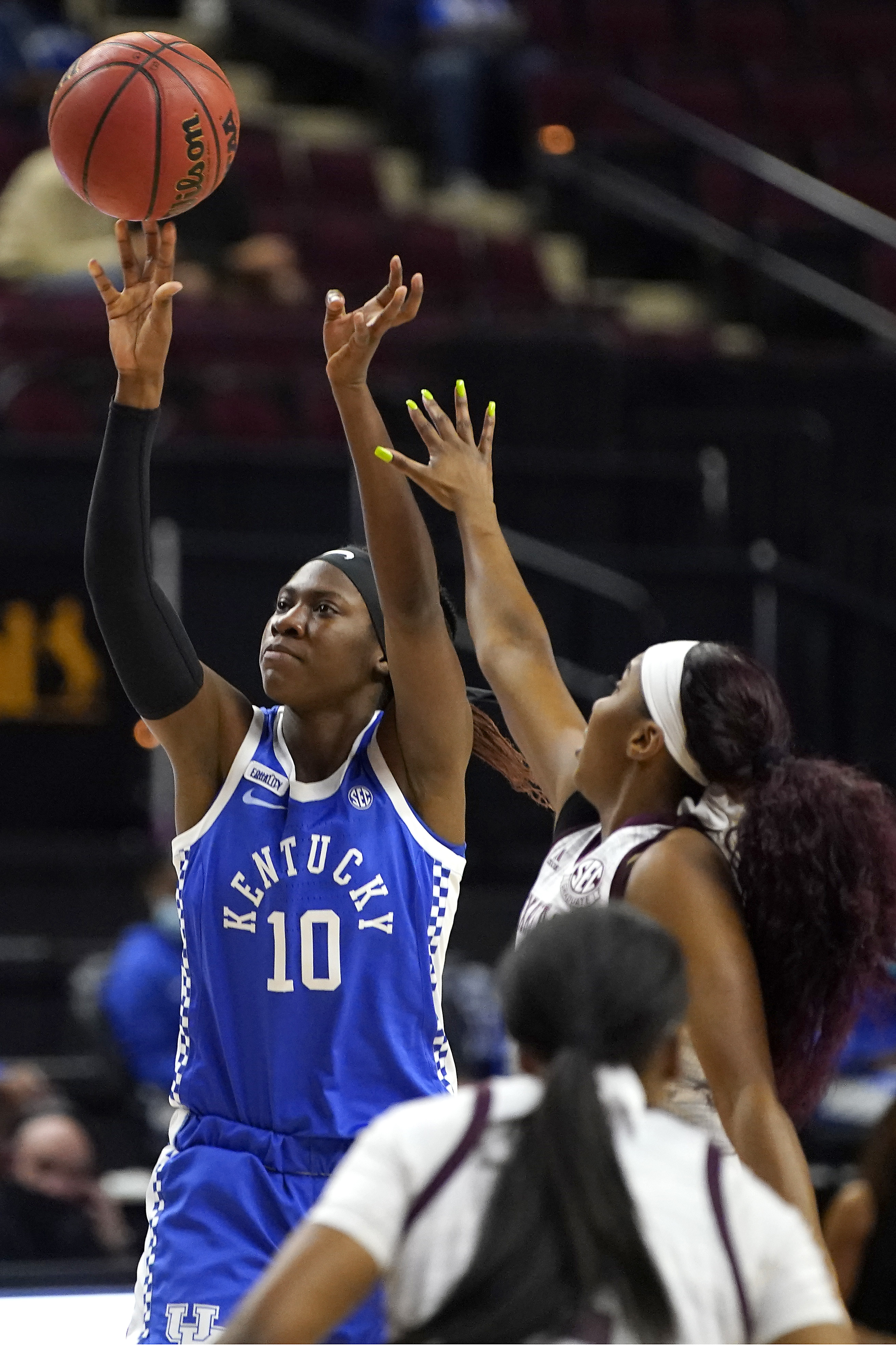 Kentucky guard Rhyne Howard (10) shoots a ball as Texas A&M guard Kayla Wells (11) defends during the first half of an NCAA college basketball game Thursday, Jan. 7 2021, in College Station, Texas. (AP Photo/Sam Craft)