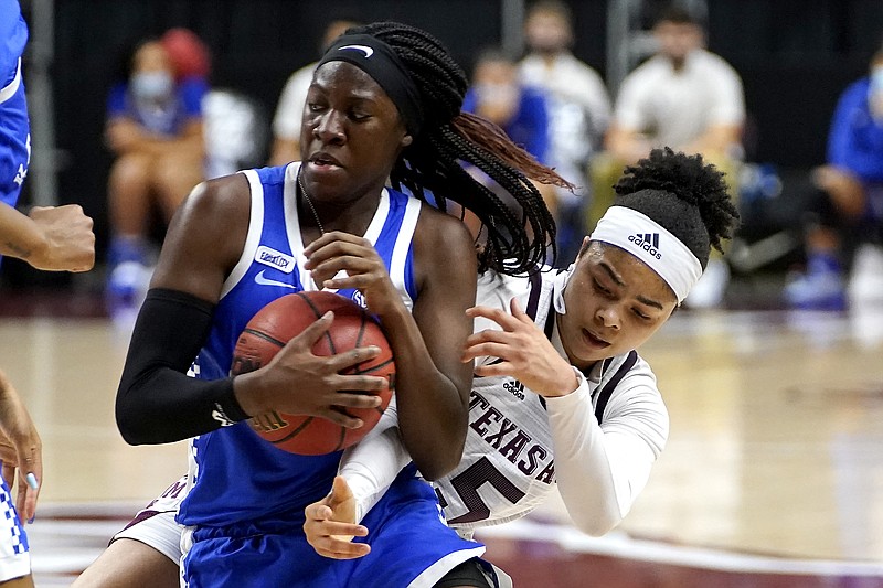 AP photo by Sam Craft / Kentucky guard Rhyne Howard grabs the basketball in front of Texas A&M guard Jordan Nixon on Jan. 7 in College Station.