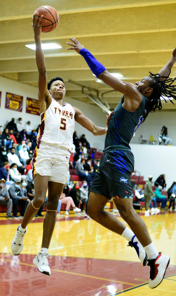 Staff Photo by Robin Rudd / Tyner's Jovontay Ross (5) puts a shot over Red Bank's Kel Eddins (3). The Tyner Rams hosted the Red Bank Lions in the boy's TSSAA Region 3-AA Tournament Semifinals on March 2, 2021.