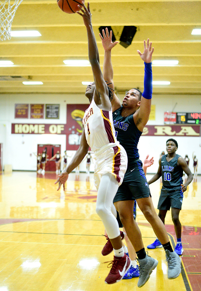 Staff Photo by Robin Rudd / Tyner's Trent Gresham (1) gets past Red Bank's Cam Bell (1) to score. The Tyner Rams hosted the Red Bank Lions in the boy's TSSAA Region 3-AA Tournament Semifinals on March 2, 2021.