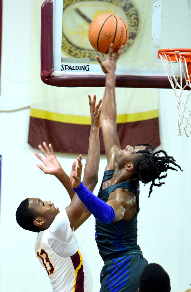 Staff Photo by Robin Rudd / Red Bank's Kel Eddins (3) blocks the shot of Tyner's Keelan Jackson (13). The Tyner Rams hosted the Red Bank Lions in the boy's TSSAA Region 3-AA Tournament Semifinals on March 2, 2021.