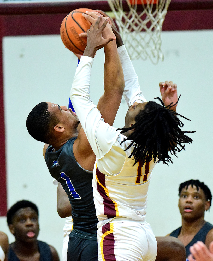 Staff Photo by Robin Rudd / Red Bank's Cam Bell and Tyner's Keilan Holloway (11) vie for a rebound. The Tyner Rams hosted the Red Bank Lions in the boy's TSSAA Region 3-AA Tournament Semifinals on March 2, 2021.