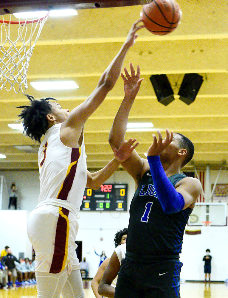 Staff Photo by Robin Rudd / Tyner's Amarion Dillard (3) blocks the shot of Red Banks Cam Bell (1). The Tyner Rams hosted the Red Bank Lions in the boy's TSSAA Region 3-AA Tournament Semifinals on March 2, 2021.