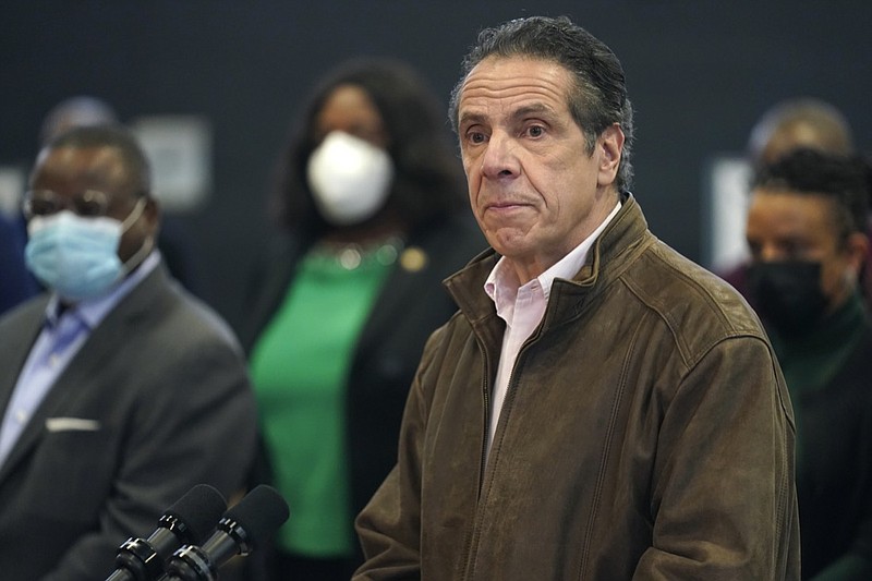 FILE - In this Feb. 22, 2021 photo, New York Gov. Andrew Cuomo, right, pauses to listen to a reporter's question during a news conference at a COVID-19 vaccination site in the Brooklyn borough of New York. New York's attorney general said she's moving forward with an investigation into sexual harassment allegations against the governor after receiving a letter from his office Monday authorizing her to take charge of the probe. (AP Photo/Seth Wenig, Pool, file)
